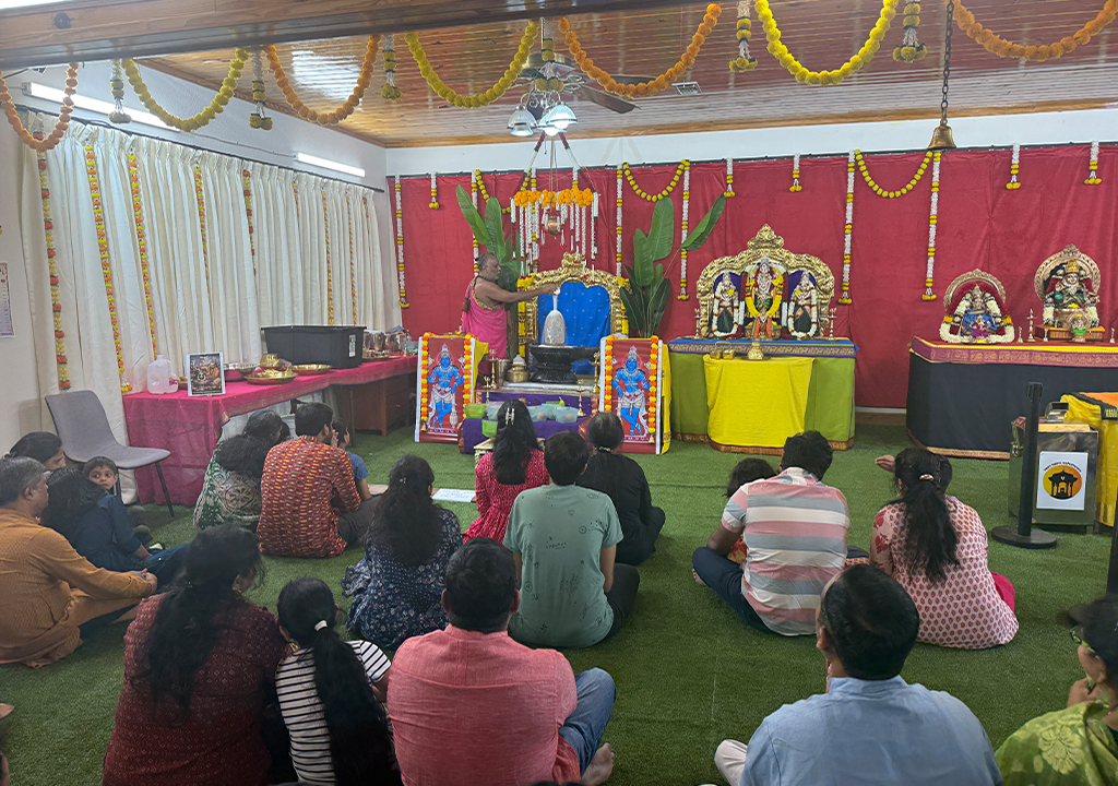 Devotees gathered inside Hari Hara Kshethram temple attending Abhishekam and participating in spiritual rituals.